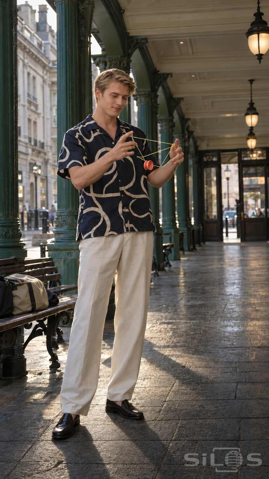 Yo-yo trick with yellow string and a coral spool, performed by a man in a patterned shirt beneath green arcade columns.