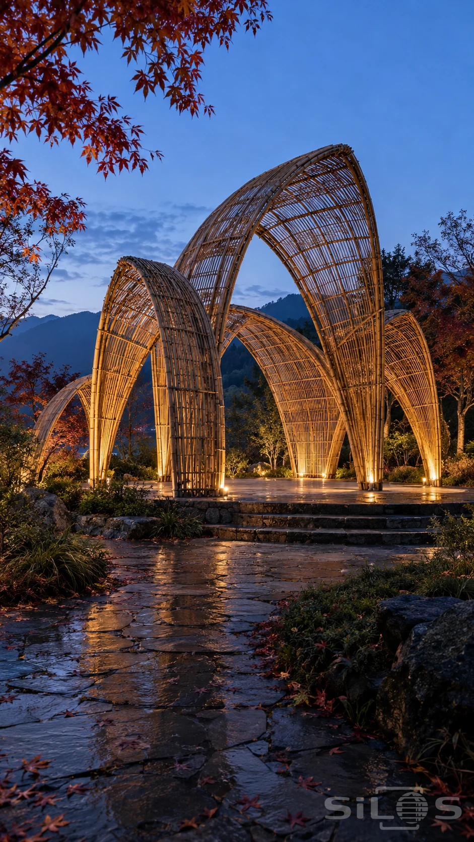 Tall transparent bamboo arches overlap on a stone terrace at blue hour, framed by autumn maples and a wet garden path.