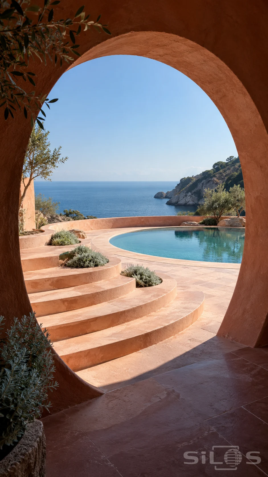 A thick round terracotta portal frames crescent steps with planting wells and a circular pool overlooking a blue coastal bay.